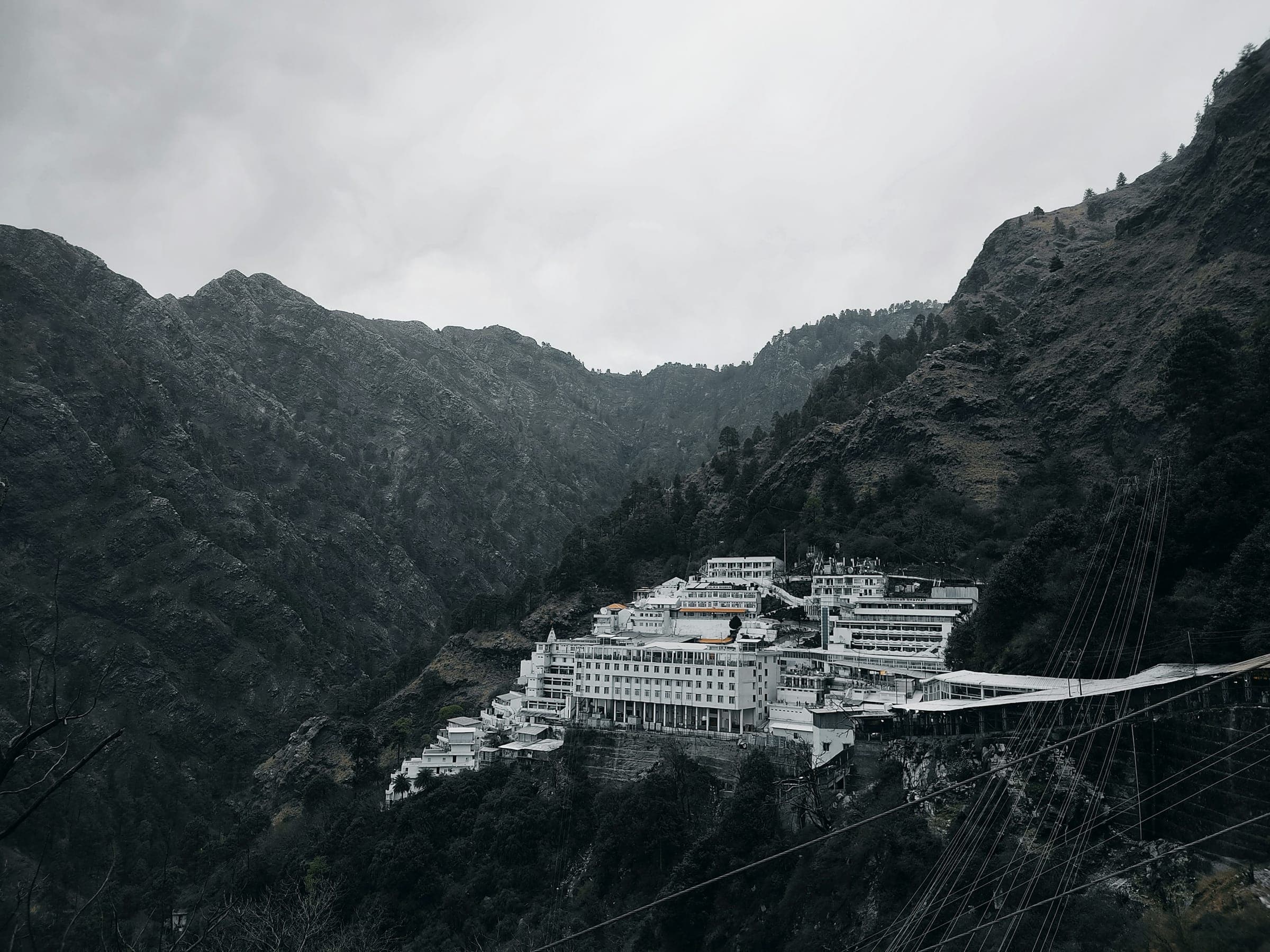 The Vaishno Devi shrine complex tucked into a misty mountainside above Katra