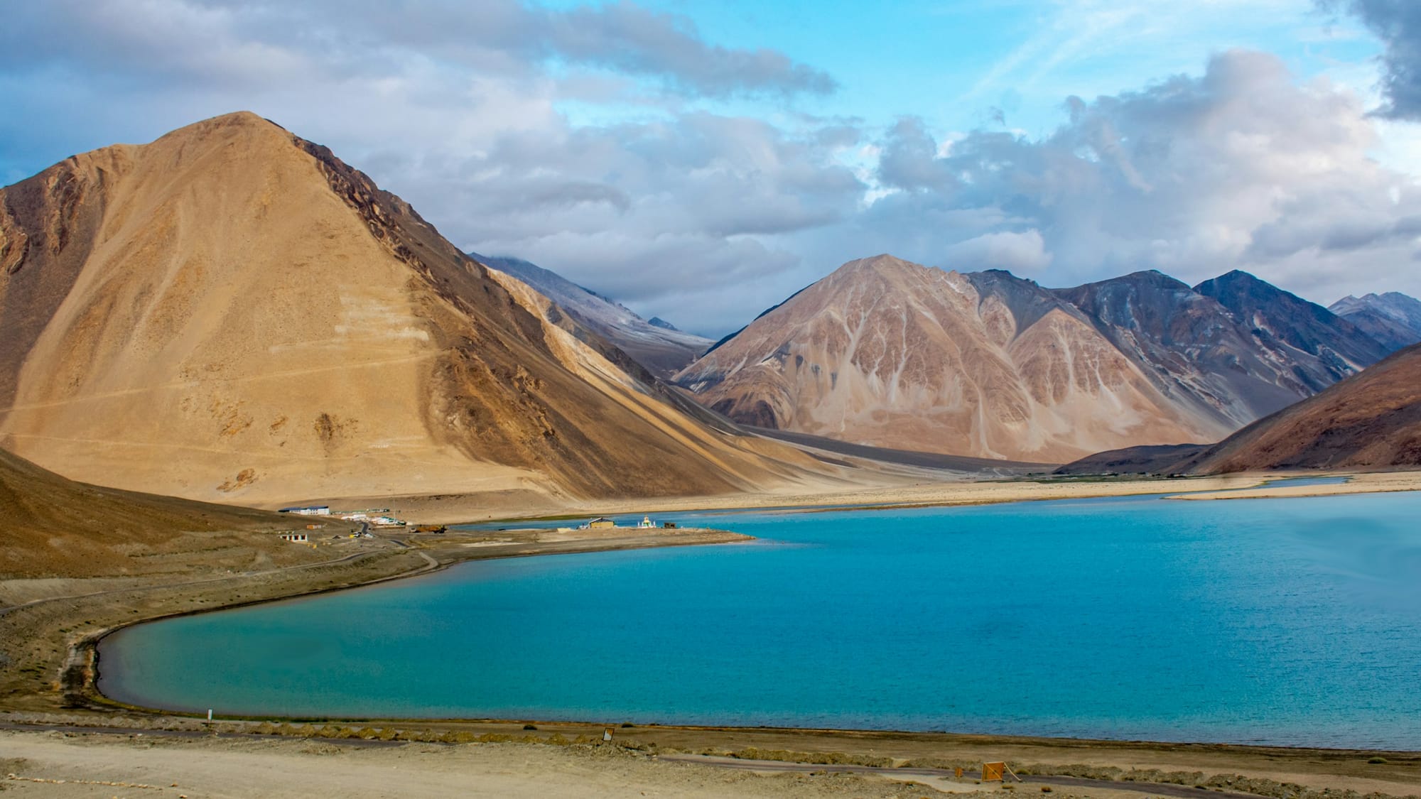 The turquoise water of Pangong Tso beneath brown Ladakh mountains